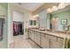 Spa-like bathroom with granite countertops, double sinks, and walk-in closet at 5521 Limelight Dr, Apollo Beach, FL 33572