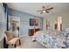 Bright bedroom with a post bed, ceiling fan, and view into another room at 5521 Limelight Dr, Apollo Beach, FL 33572