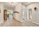 Bright and spacious hallway with wood-look tile flooring and access to living areas at 5521 Limelight Dr, Apollo Beach, FL 33572