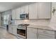 Well-equipped kitchen with granite counters and gas range at 5521 Limelight Dr, Apollo Beach, FL 33572
