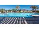 Relaxing community pool with lounge chairs and palm trees at 10348 Blue Plume Ct, Riverview, FL 33578