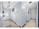 Bright hallway with light grey walls and white doors at 1146 81St N Ave, St Petersburg, FL 33702