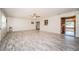 Spacious living room with light wood floors, a ceiling fan, and a view into the sun room at 2342 Hazelwood Ln, Clearwater, FL 33763