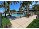 Community lap pool with lounge chairs and patio umbrellas at 410 Islebay Dr, Apollo Beach, FL 33572