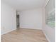 Simple living room with hardwood floors and a window with blinds at 4406 W Wallcraft Ave, Tampa, FL 33611