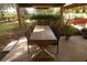 Rustic wooden table with chairs on a paved patio at 468 Limewood Ave, Dunedin, FL 34698