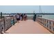 Wooden walkway along a calm body of water with people at 468 Limewood Ave, Dunedin, FL 34698