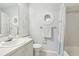 Bathroom with tub, vanity, and coastal decor at 12049 Hoosier Ct # 202, Hudson, FL 34667