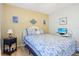 Bedroom with a queen-size bed and coastal decor at 12049 Hoosier Ct # 202, Hudson, FL 34667