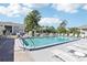Inviting community pool with lounge chairs, ready for relaxation at 12049 Hoosier Ct # 202, Hudson, FL 34667