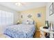 Bedroom with a queen-size bed and coastal decor at 12049 Hoosier Ct # 202, Hudson, FL 34667