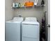 Bright laundry room with washer, dryer, and overhead shelving at 10348 Blue Plume Ct, Riverview, FL 33578