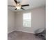 Simple bedroom with ceiling fan and window at 10348 Blue Plume Ct, Riverview, FL 33578