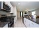 Modern kitchen with granite countertops and stainless steel appliances at 10348 Blue Plume Ct, Riverview, FL 33578