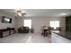 Living room with couch, TV, and adjacent dining area at 10348 Blue Plume Ct, Riverview, FL 33578