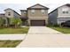 Two-story home with a two-car garage and landscaping at 10348 Blue Plume Ct, Riverview, FL 33578