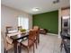 Dining area with green accent wall and wood table at 10348 Blue Plume Ct, Riverview, FL 33578