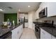 Modern kitchen with granite countertops and stainless steel appliances at 10348 Blue Plume Ct, Riverview, FL 33578