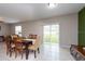 Bright dining room with sliding glass doors to backyard at 10348 Blue Plume Ct, Riverview, FL 33578