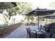 Outdoor patio with fire pit and umbrella-covered seating at 36750 Us Highway 19 # 21212, Palm Harbor, FL 34684
