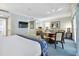 Bright bedroom suite with a king bed, dining table, and flat-screen TV at 36750 Us Highway 19 # 21212, Palm Harbor, FL 34684