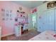 Pink-themed bedroom with a desk, closet, and upper loft access at 29798 Chapel Chase Dr, Wesley Chapel, FL 33545