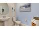 Clean and modern powder room with white vanity and light blue walls at 29798 Chapel Chase Dr, Wesley Chapel, FL 33545