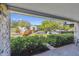 Brick patio with lush landscaping and partial view of parking lot at 36750 Us Highway 19 N # 19106, Palm Harbor, FL 34684