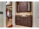 Convenient wet bar with dark wood cabinetry and granite countertops at 7734 Still Lakes Dr, Odessa, FL 33556