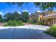 Luxury home with lush landscaping and brick driveway at 7734 Still Lakes Dr, Odessa, FL 33556