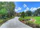 Long driveway leading to a luxurious two-story house at 7734 Still Lakes Dr, Odessa, FL 33556