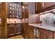 Spacious pantry with glass-front cabinets and granite countertops at 7734 Still Lakes Dr, Odessa, FL 33556