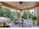 Covered patio overlooking tranquil lake views with comfortable seating at 7734 Still Lakes Dr, Odessa, FL 33556