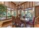 Breakfast room with window views, chandelier, and seating for six at 7734 Still Lakes Dr, Odessa, FL 33556