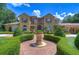 Elegant entryway with ornate fountain and double doors at 7734 Still Lakes Dr, Odessa, FL 33556