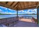 Lakefront dock with a shaded seating area, perfect for enjoying the waterfront at 7734 Still Lakes Dr, Odessa, FL 33556