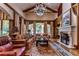 Spacious living room with hardwood floors, fireplace, and large windows at 7734 Still Lakes Dr, Odessa, FL 33556