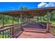 Covered wooden dock offering scenic lake views and a relaxing atmosphere at 7734 Still Lakes Dr, Odessa, FL 33556