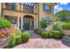 Grand entrance to a luxurious home with a meticulously landscaped front yard at 7734 Still Lakes Dr, Odessa, FL 33556