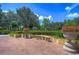 Serene patio area with lush landscaping and a stone bench at 7734 Still Lakes Dr, Odessa, FL 33556