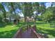 Wooden footbridge leading to the backyard of a lakefront estate at 7734 Still Lakes Dr, Odessa, FL 33556