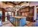 Open kitchen with large island, hardwood floors, and access to Gathering room at 7734 Still Lakes Dr, Odessa, FL 33556