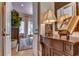 Elegant entryway with ornate furniture and a glimpse of a sitting area at 7734 Still Lakes Dr, Odessa, FL 33556