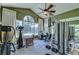 Bright home gym with various exercise equipment and a view of the backyard at 7734 Still Lakes Dr, Odessa, FL 33556