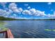 Stunning view of a serene lake with lush greenery and a tranquil ambiance at 7734 Still Lakes Dr, Odessa, FL 33556