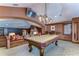 Elegant billiards room with a classic pool table and seating area at 7734 Still Lakes Dr, Odessa, FL 33556