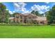 Two-story house with manicured lawn, and landscaping at 7734 Still Lakes Dr, Odessa, FL 33556