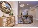 Elegant upper hallway with ornate staircase and decorative dresser at 7734 Still Lakes Dr, Odessa, FL 33556