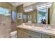 Spa-like bathroom with double vanity, glass shower, and elegant fixtures at 7734 Still Lakes Dr, Odessa, FL 33556