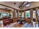 Spacious living room with hardwood floors, fireplace, and large windows at 7734 Still Lakes Dr, Odessa, FL 33556